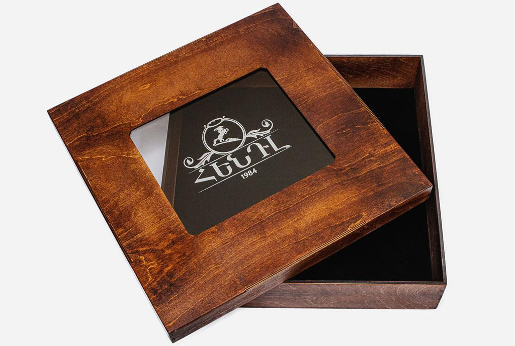 Wooden presentation box open beside the carved chess board