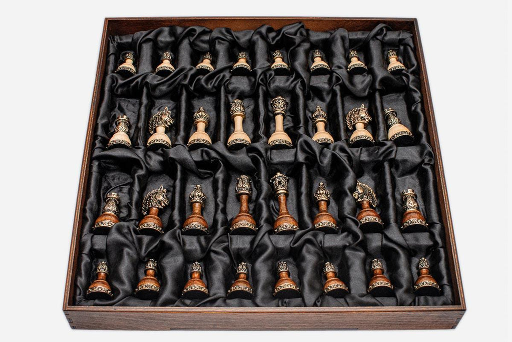 Full set of brass-mounted wooden chess pieces arranged in the black satin presentation tray