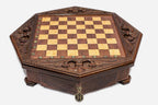 Octagonal wooden chess board shown from the front with carved border and inlaid checkered surface