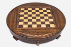 Angled view of the round carved chess set showing the diamond-lattice border and inlaid checkered board