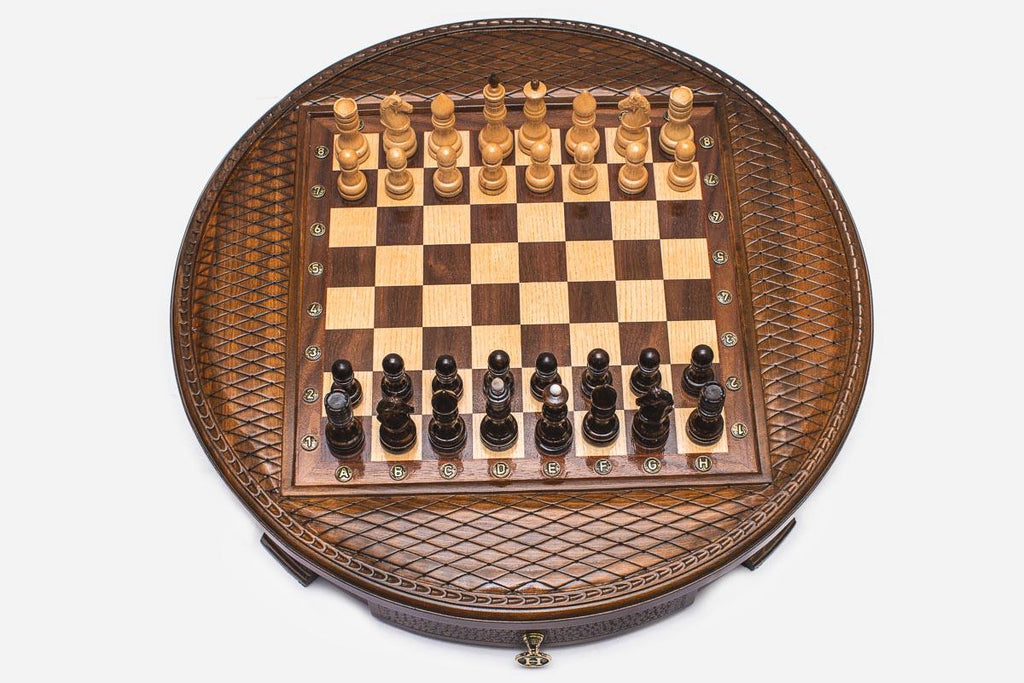 Round wooden chess set with woven lattice-carved border and wooden pieces set up on the inlaid board