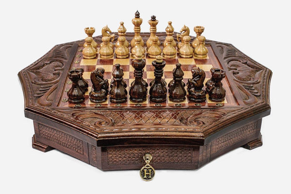 Octagonal wooden chess set in warm mahogany finish with carved acanthus corners and wooden pieces set up for play