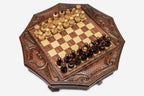 Top-down view of the mahogany octagonal chess board with pieces set up and carved corner scrollwork