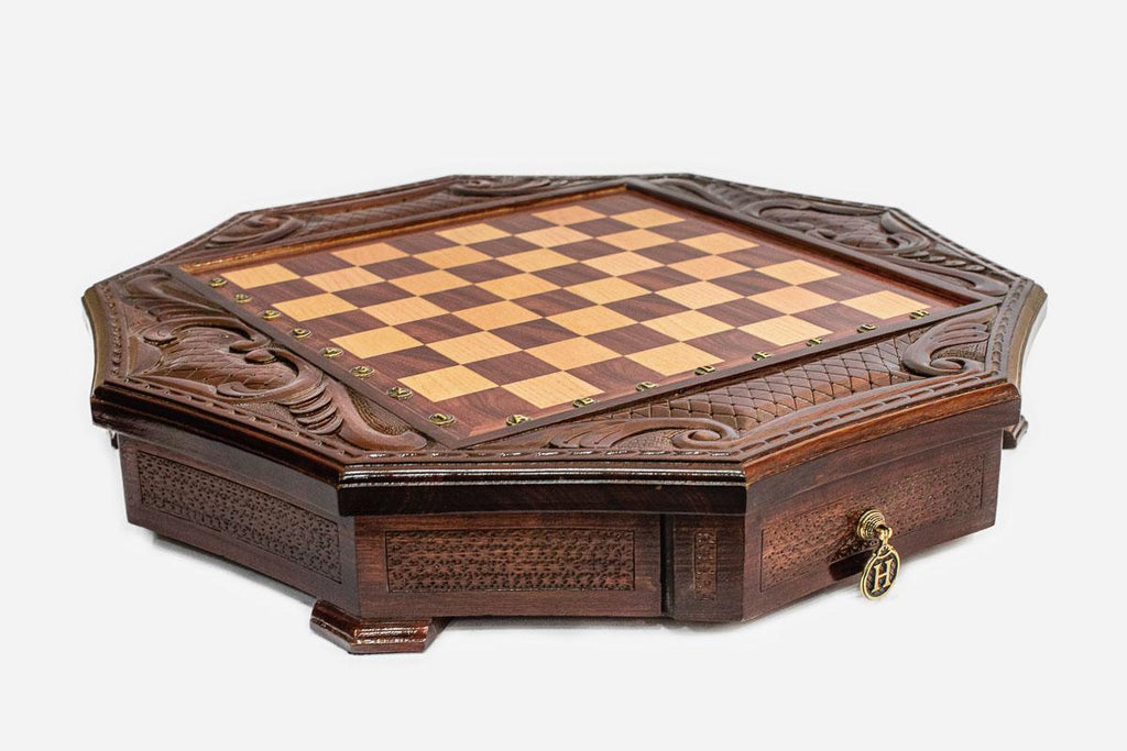 Empty mahogany octagonal chess board with carved acanthus corners and diamond-lattice border