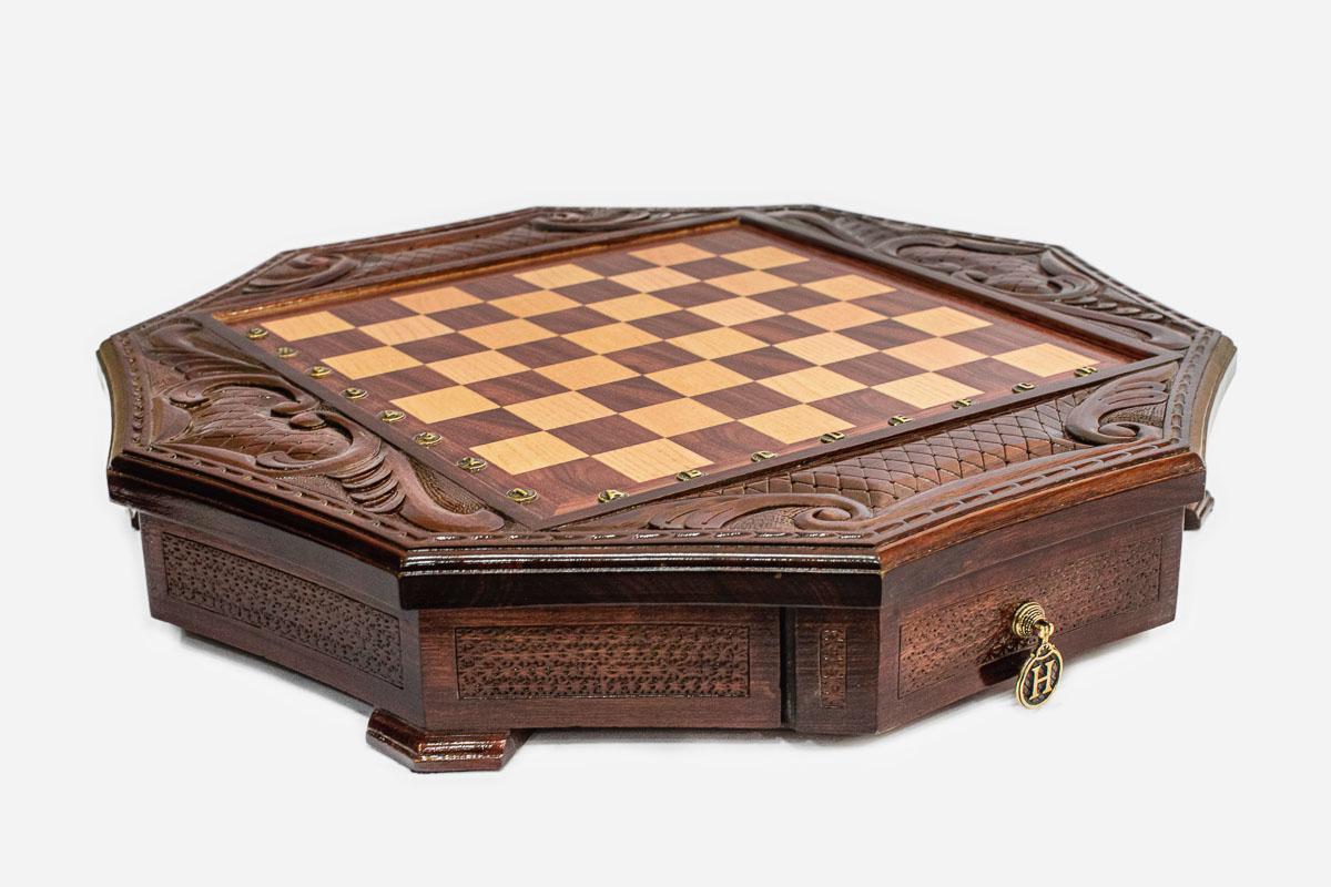 Empty mahogany octagonal chess board with carved acanthus corners and diamond-lattice border
