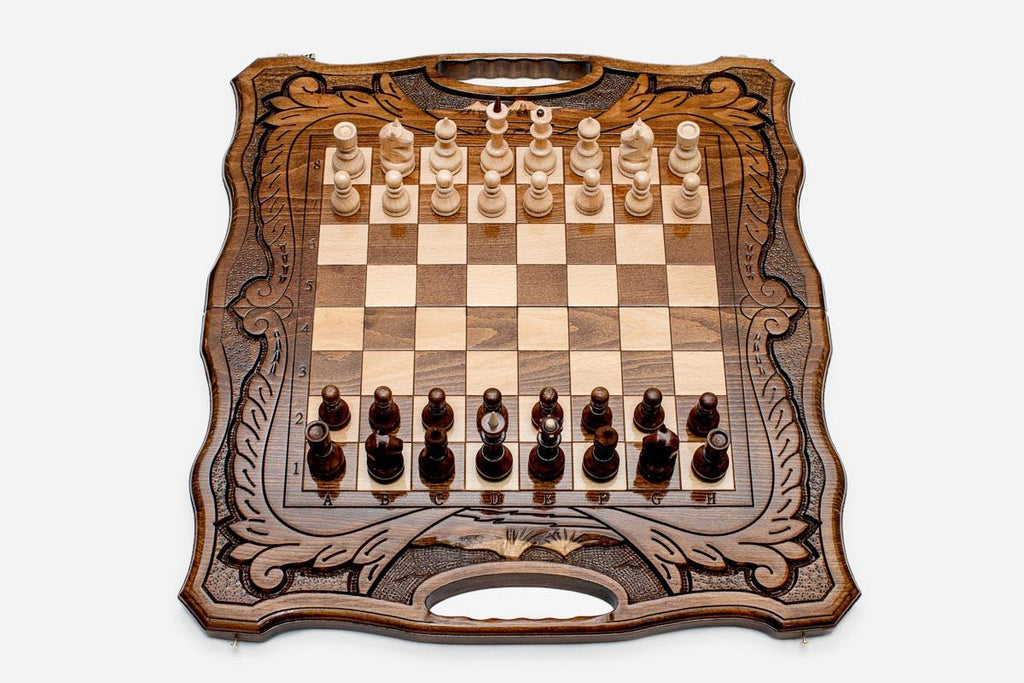 Armenian walnut chess set with a Mount Ararat inlay and carved frame, pieces in starting position