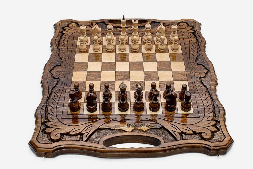 Angled view of the folding walnut chess set showing its carved frame