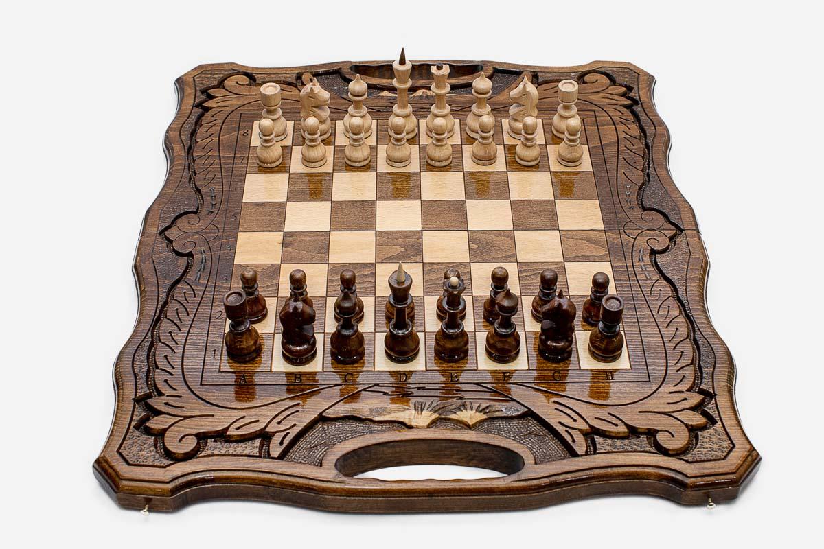 Angled view of the folding walnut chess set showing its carved frame