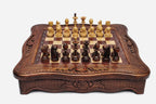 Handmade wooden chess set with carved scalloped frame and wooden pieces arranged on the walnut and maple board
