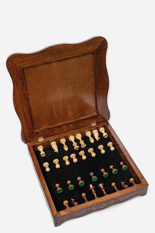 Chess pieces stored in the felt-lined interior of the wooden chess set