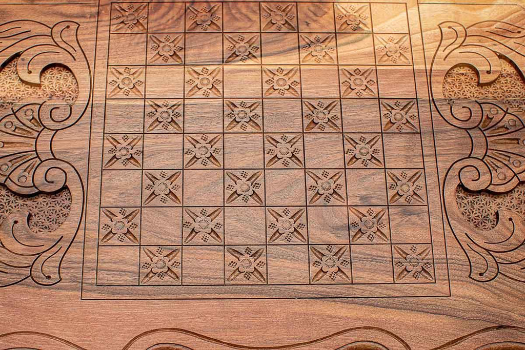Carved floral square pattern detail on the walnut backgammon board