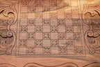 Carved floral square pattern detail on the walnut backgammon board