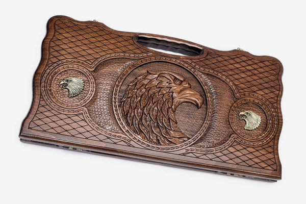 Carved beechwood backgammon board with a bronze-accented eagle, propped open