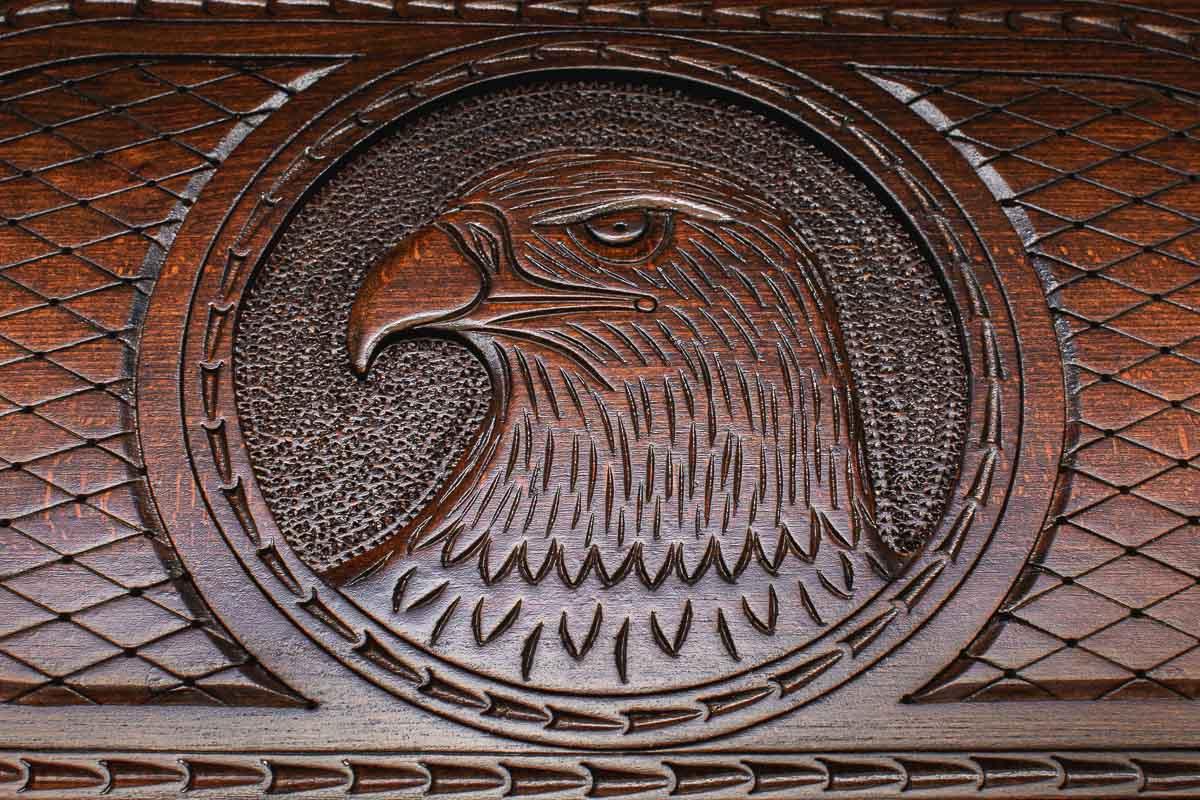 Close-up of hand-carved eagle head in stippled beech