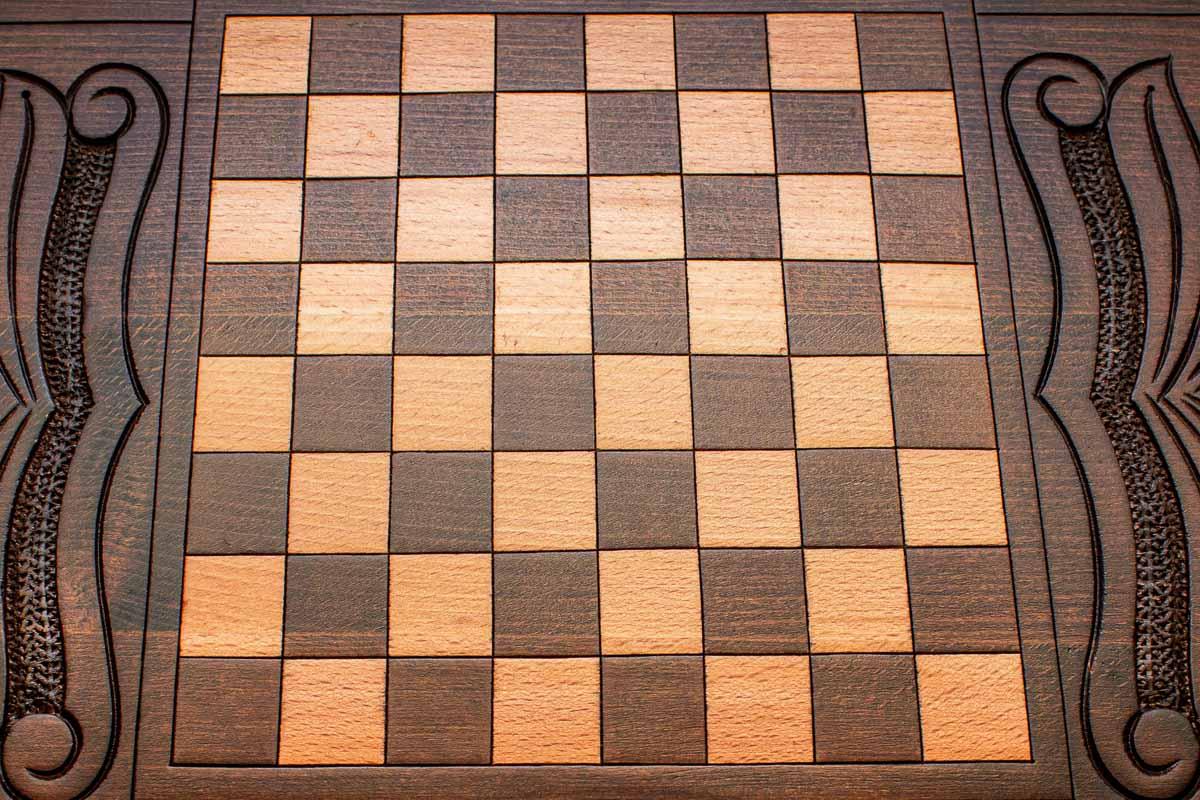 The backgammon board opened to show the wooden playing surface