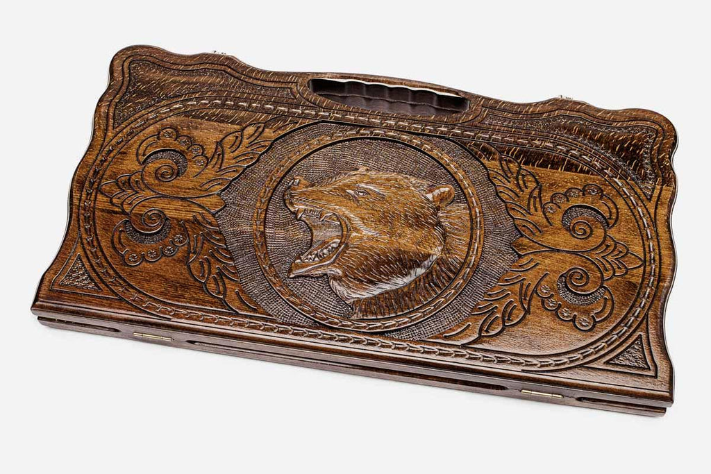 Carved beechwood backgammon board with a standing bear and carry handle, propped open