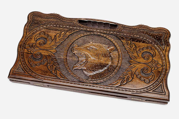Carved beechwood backgammon board with a standing bear and carry handle, propped open