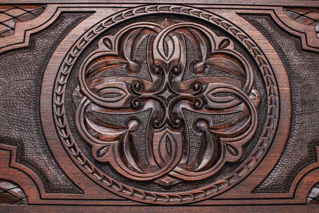 Hand-carved interlaced knot ornament close-up on backgammon board