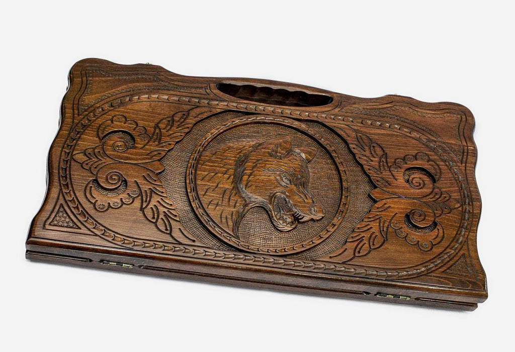 Carved beechwood backgammon board with a prowling wolf and carry handle, propped open