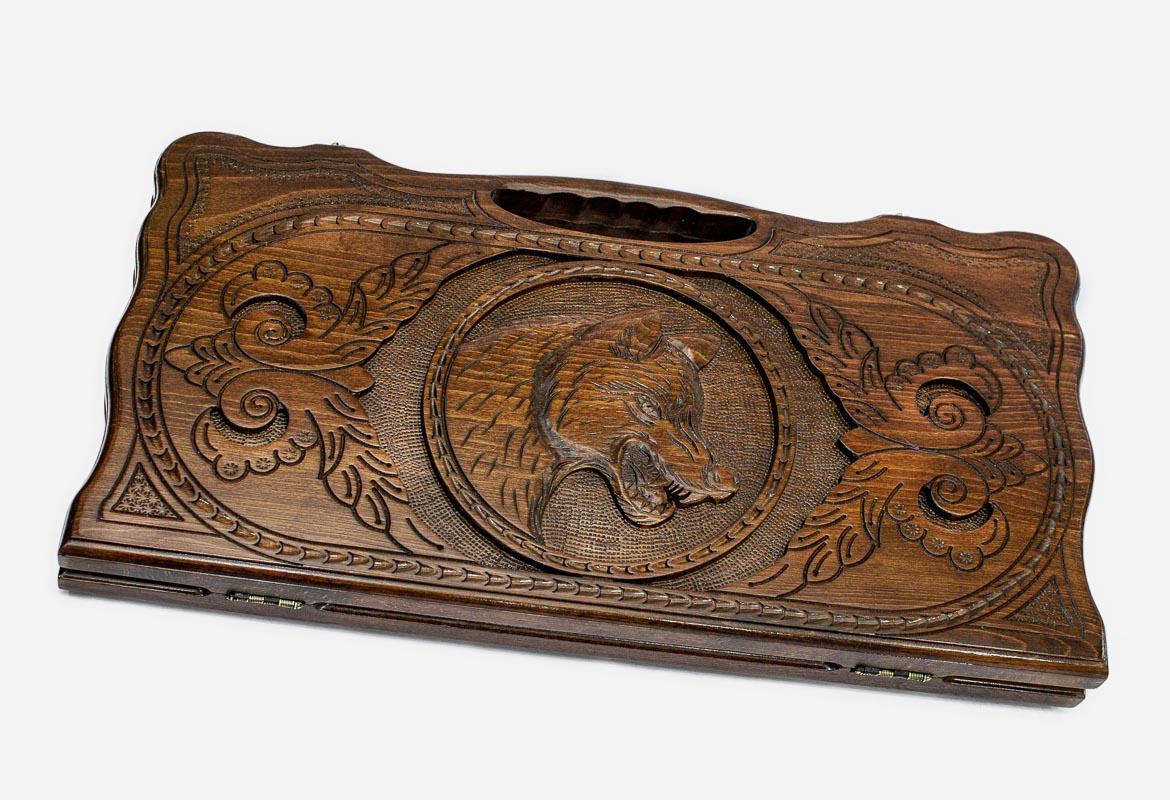 Carved beechwood backgammon board with a prowling wolf and carry handle, propped open