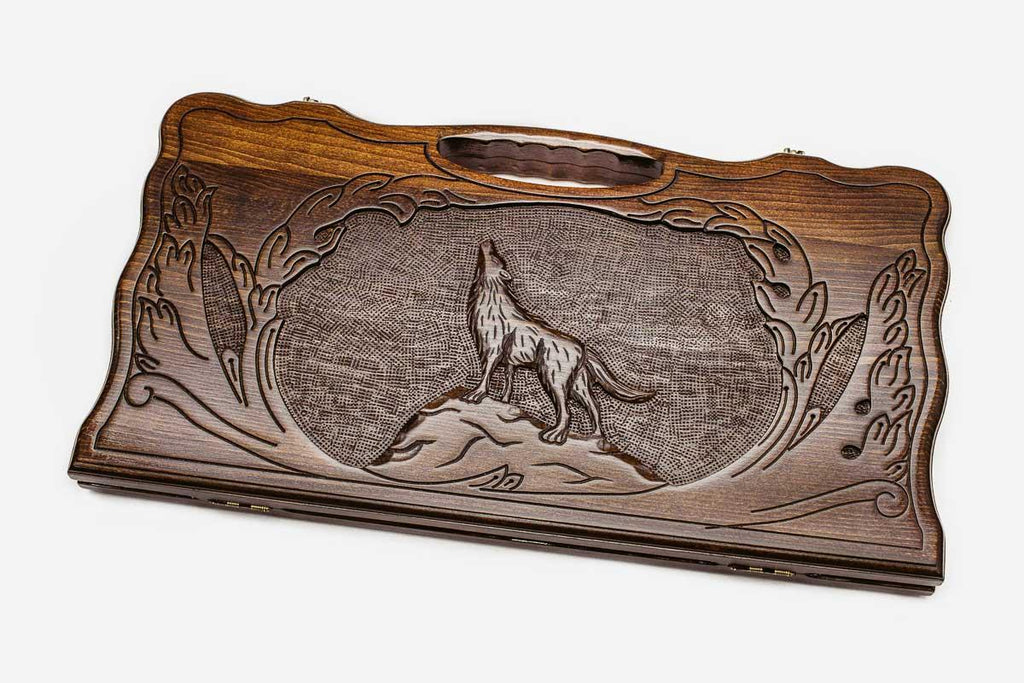 Carved beechwood backgammon board with a grey wolf and carry handle, propped open