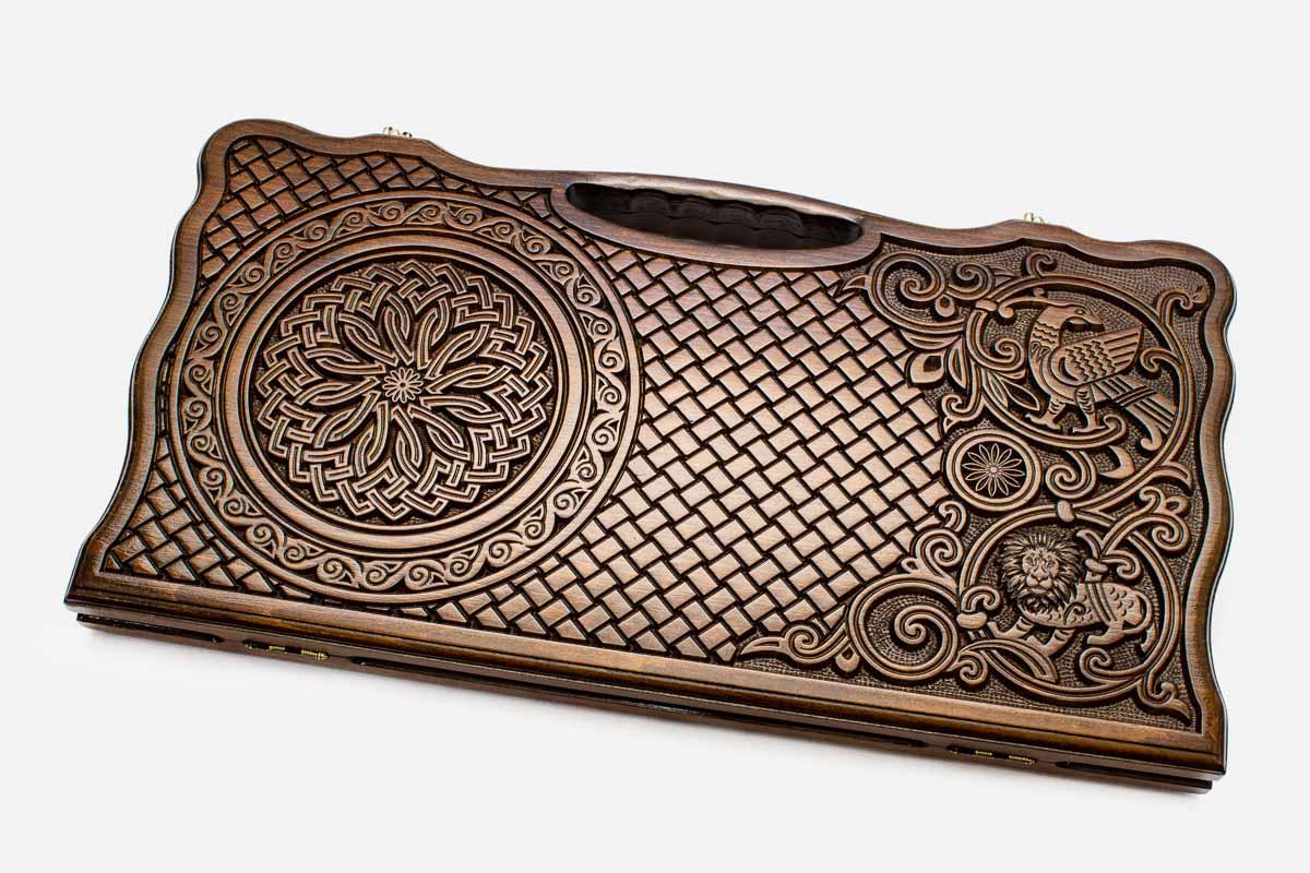 Carved beechwood backgammon board with interlaced ornament and an eagle, propped open