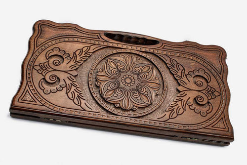 Carved beechwood backgammon board with a floral ornament, propped open