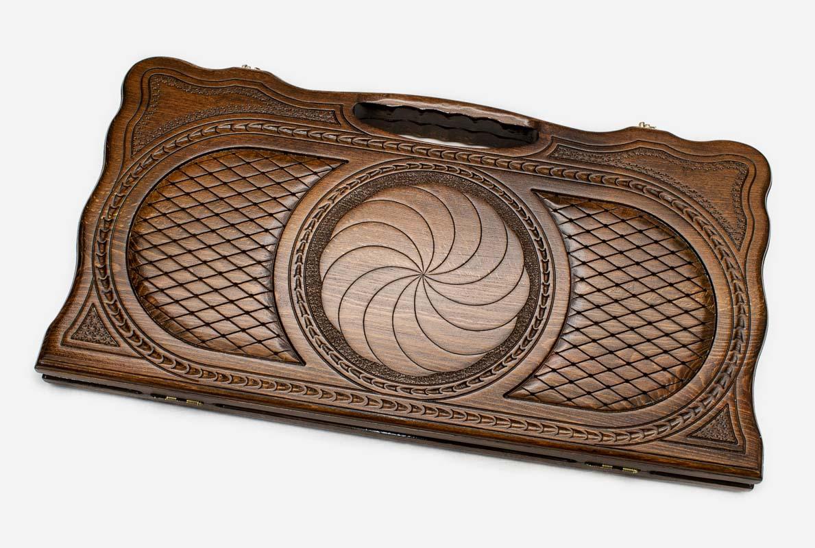 Carved beechwood backgammon board with an infinity knot and a carry handle, propped open