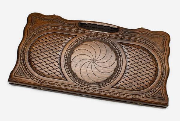 Carved beechwood backgammon board with an infinity knot and a carry handle, propped open