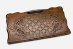 Angled view of the infinity knot carved backgammon board