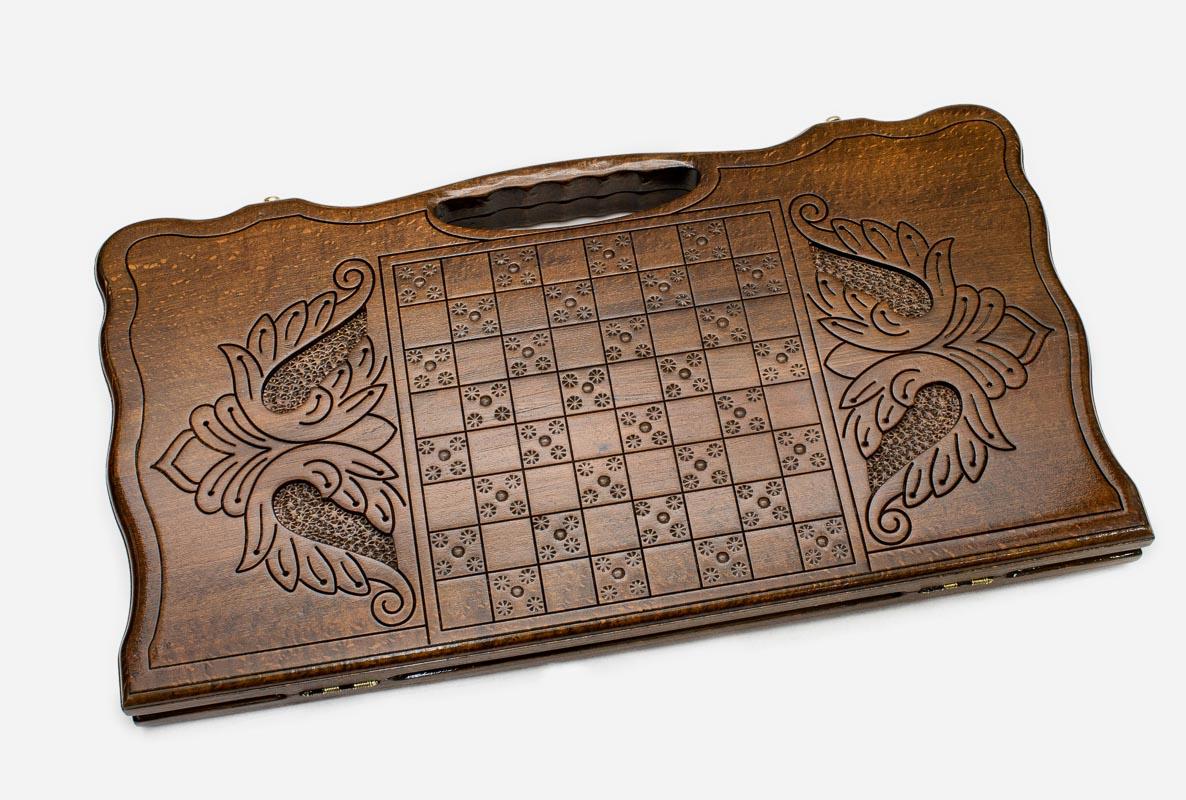Angled view of the infinity knot carved backgammon board
