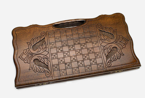 Angled view of the infinity knot carved backgammon board