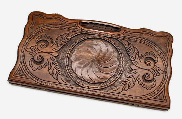 Carved beechwood backgammon board with an infinity ornament, propped open