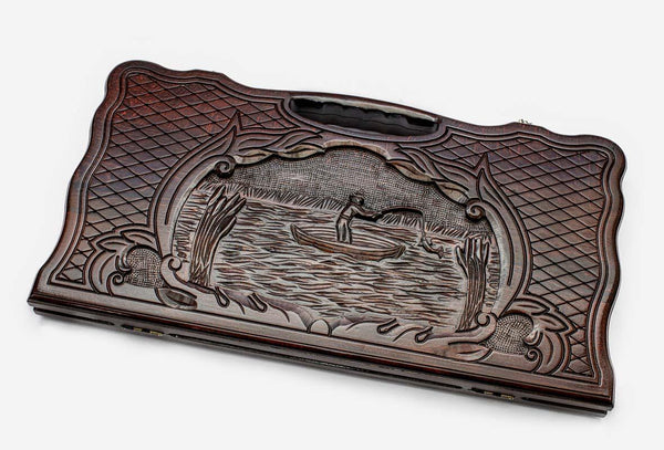 Carved beechwood backgammon board with a fisherman, propped open