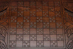 The backgammon board opened to show the wooden playing surface