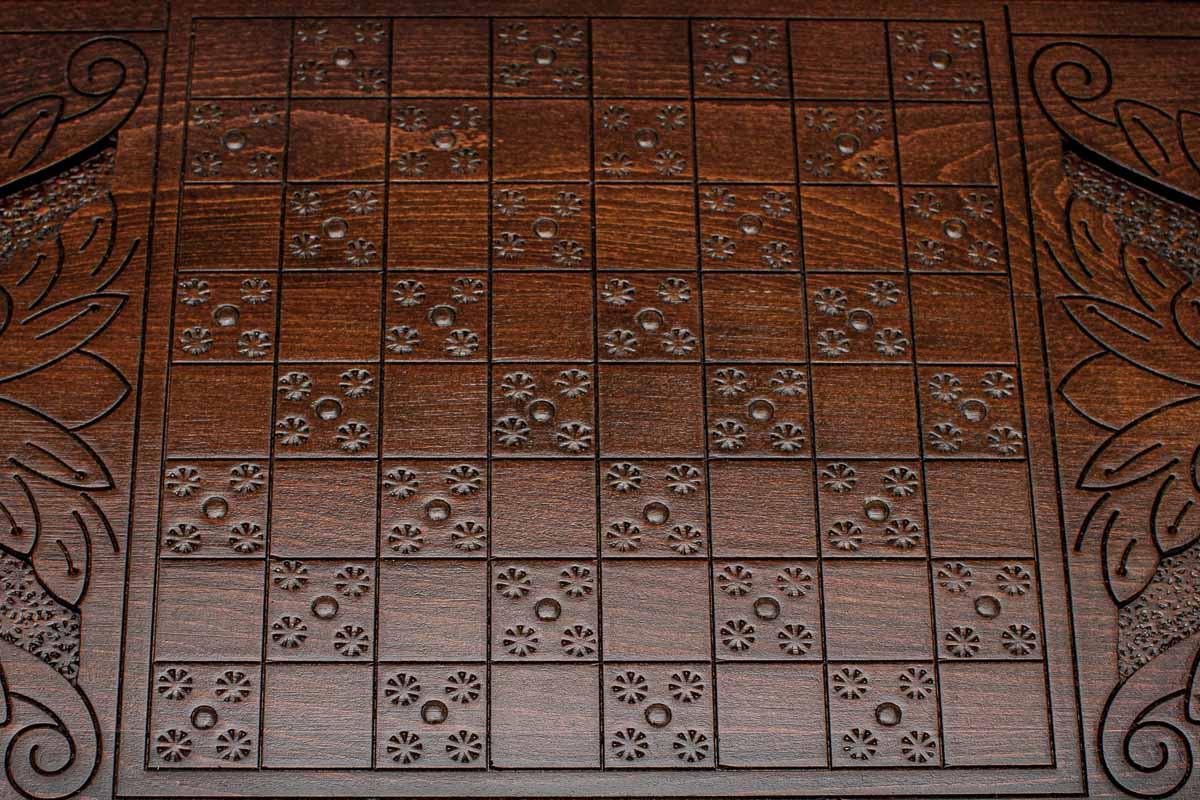 The backgammon board opened to show the wooden playing surface