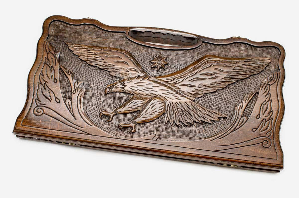 Carved beechwood backgammon board with an eagle in an octagon ornament, propped open