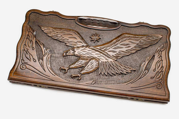 Carved beechwood backgammon board with an eagle in an octagon ornament, propped open