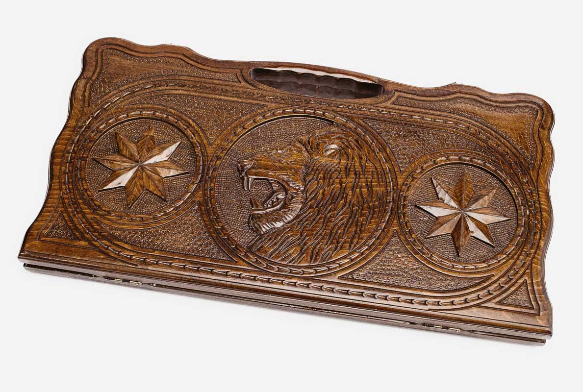 Carved beechwood backgammon board with a lion in an octagon ornament, propped open