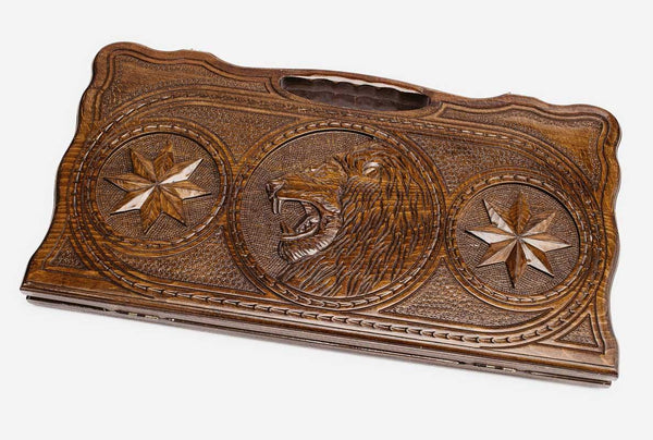 Carved beechwood backgammon board with a lion in an octagon ornament, propped open