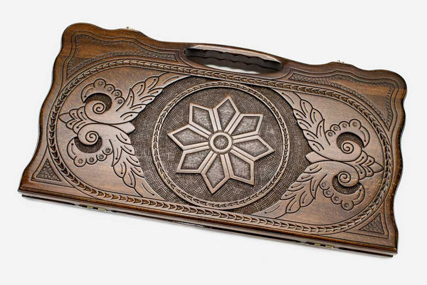 Carved beechwood backgammon board with an octagonal star ornament and a carry handle, propped open