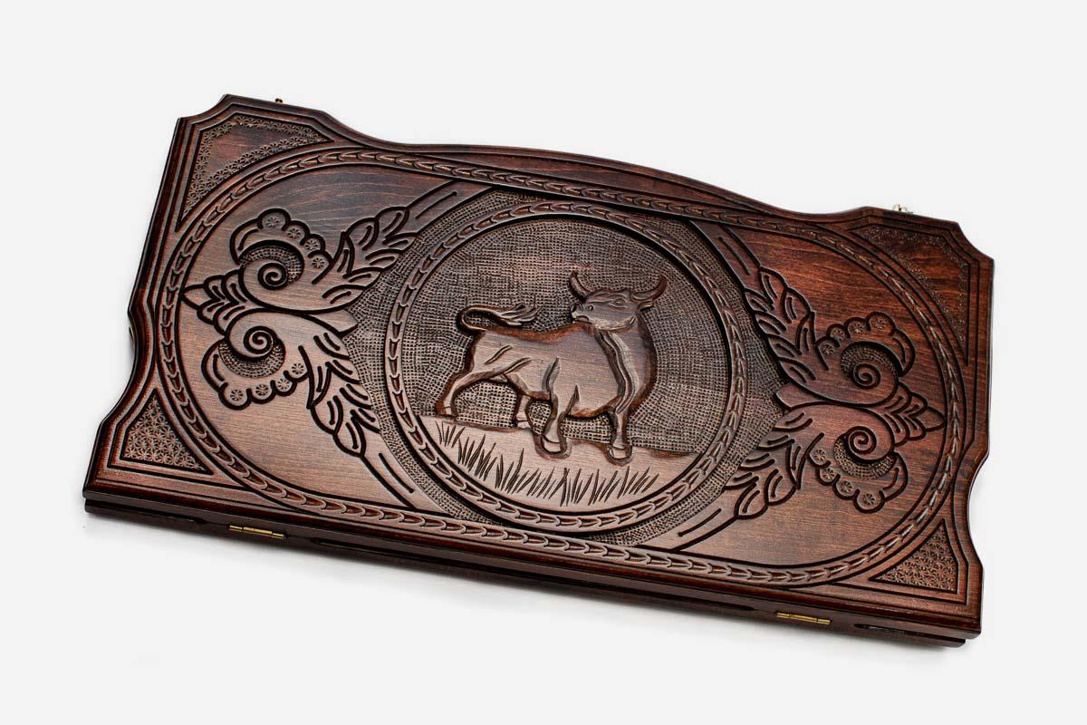 Hand-carved bull on wooden backgammon set lid