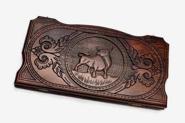 Hand-carved bull on wooden backgammon set lid