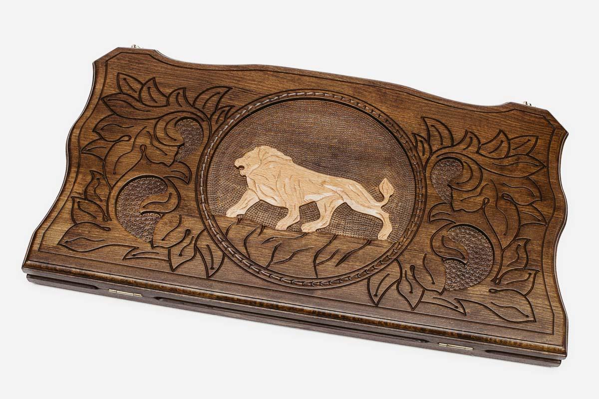 Hand-carved white lion on wooden backgammon set lid