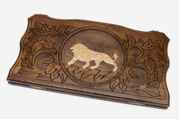 Hand-carved white lion on wooden backgammon set lid
