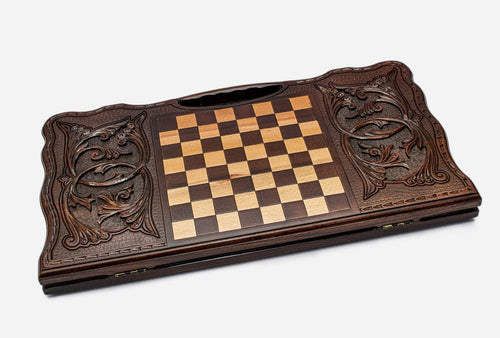 Angled view of the floral scrollwork ornament carved backgammon board
