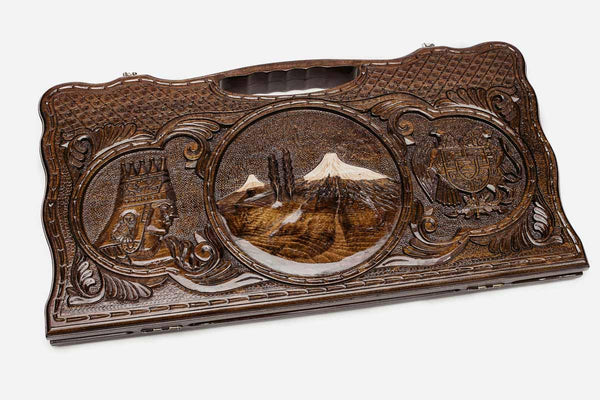 Carved beechwood backgammon board with Mount Ararat at the center and two side scenes, propped open