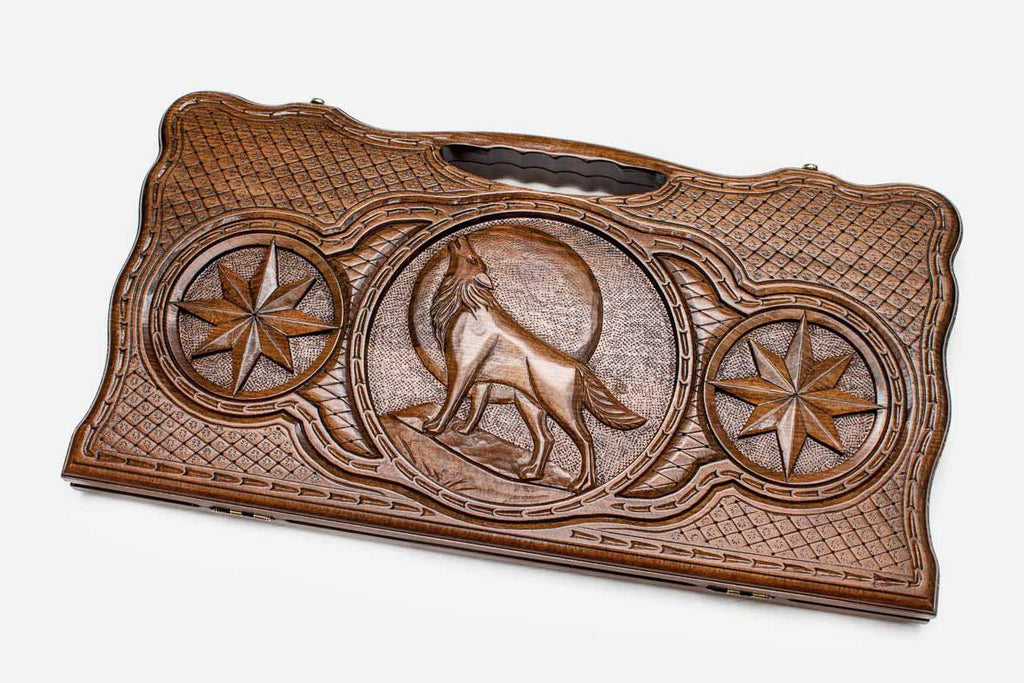Carved beechwood backgammon board with a wolf, a lion and an octagon ornament, propped open