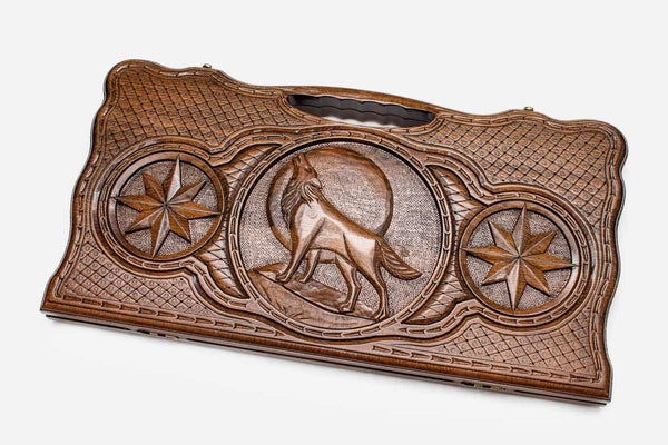 Carved beechwood backgammon board with a wolf, a lion and an octagon ornament, propped open