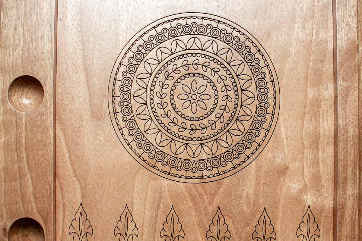 Carved carpet-border ornament on the walnut backgammon lid, close view